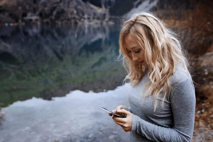 Picture of a woman outside using her phone