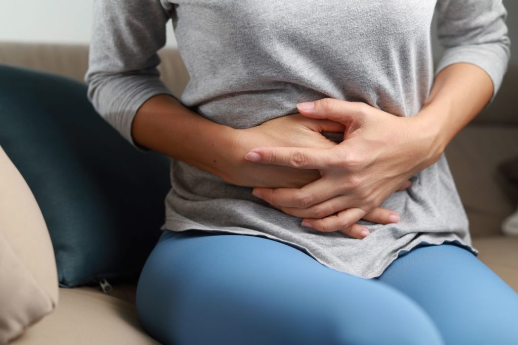 Woman experiencing stomach cramps