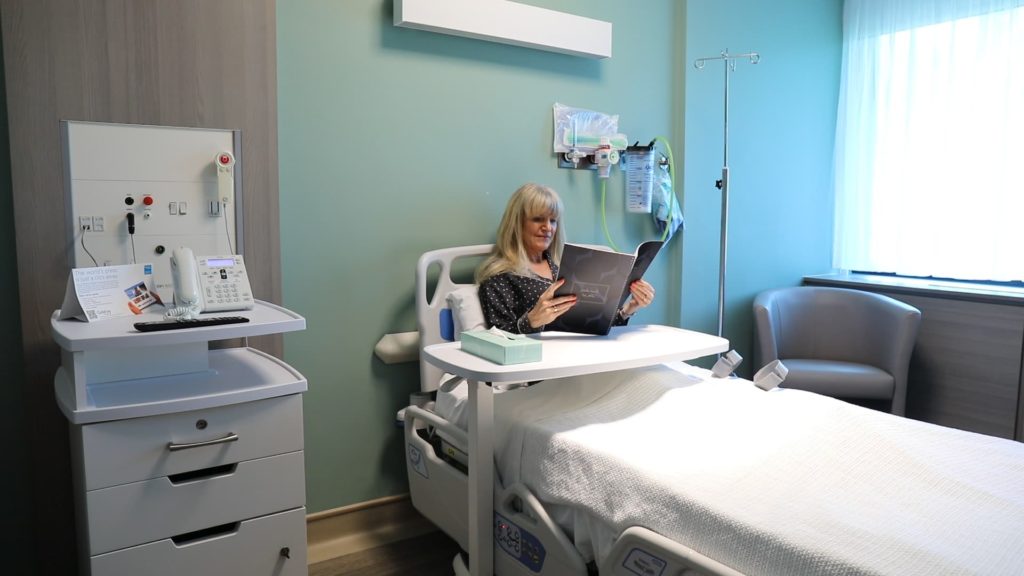 Patient in a private room reading a magazine