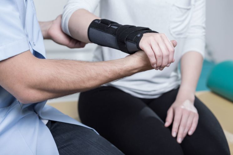 Woman having physiotherapy for a hand and wrist injury