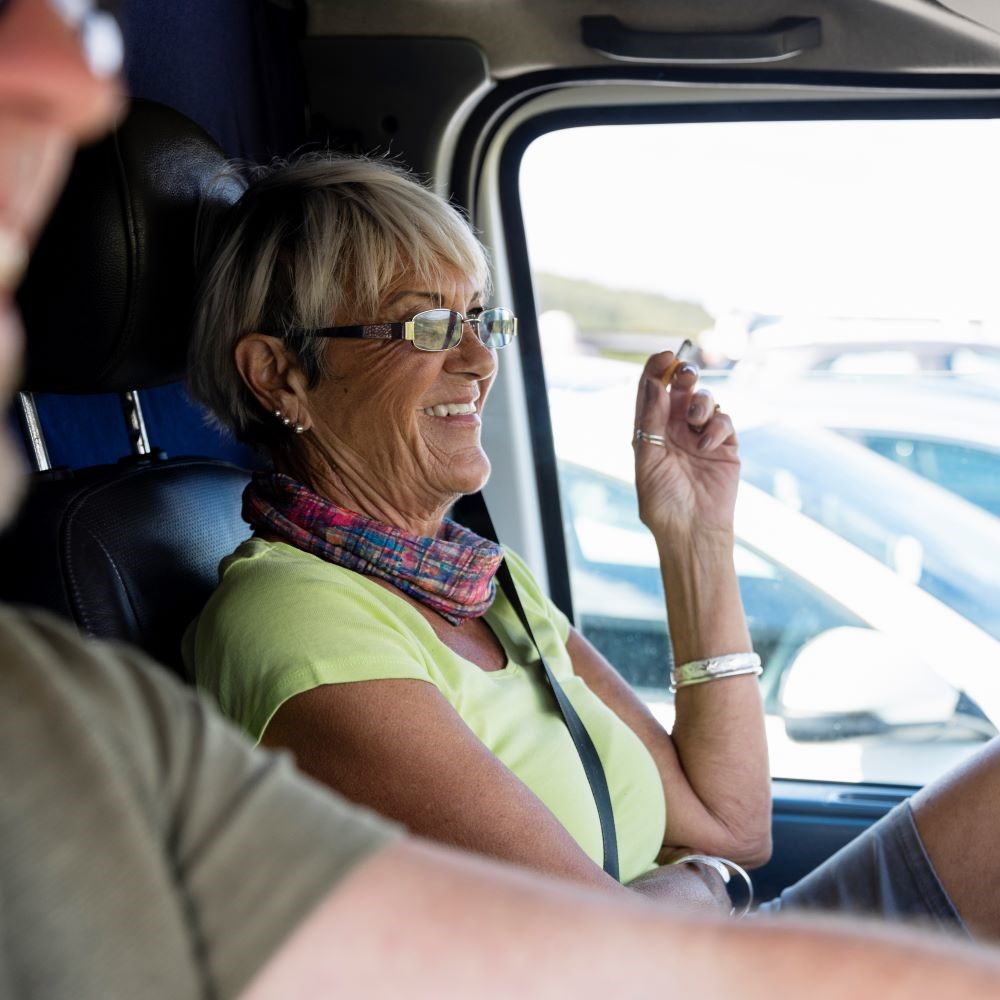 Woman smoking in car; ?>