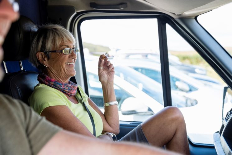 Picture of a woman smoking in the car and smiling